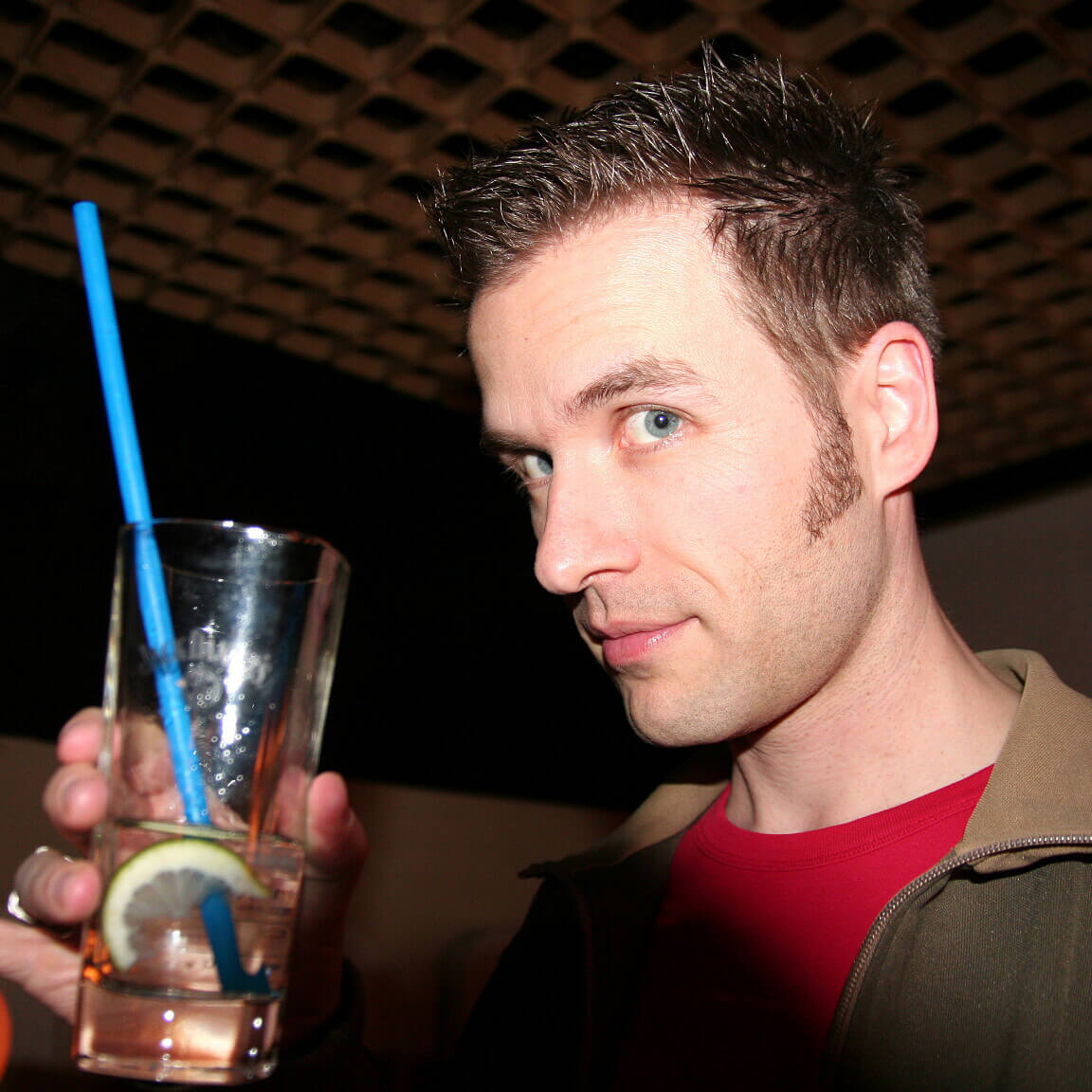 Keen employee holding up a drink to the camera
